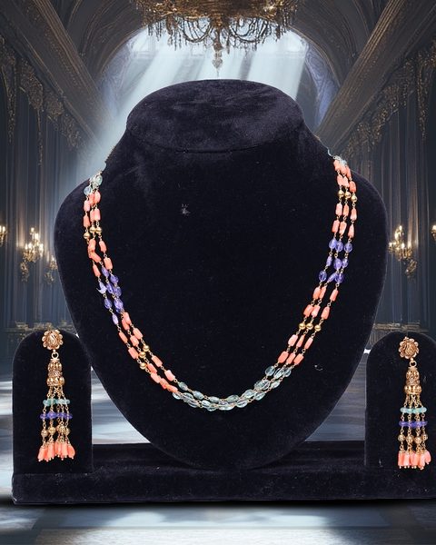 Three strand coral and blue bead necklace with gold beads, tassel earrings. Photographed at the shop.