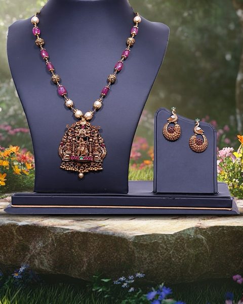 Ruby bead and pearl mala with nakshi deity pendant, peacock earrings. Photographed at the shop.