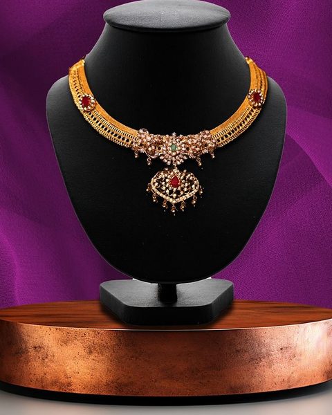 Gold mesh chain necklace with cz floral centre, ruby stones and pearl drops. Photographed at the shop.