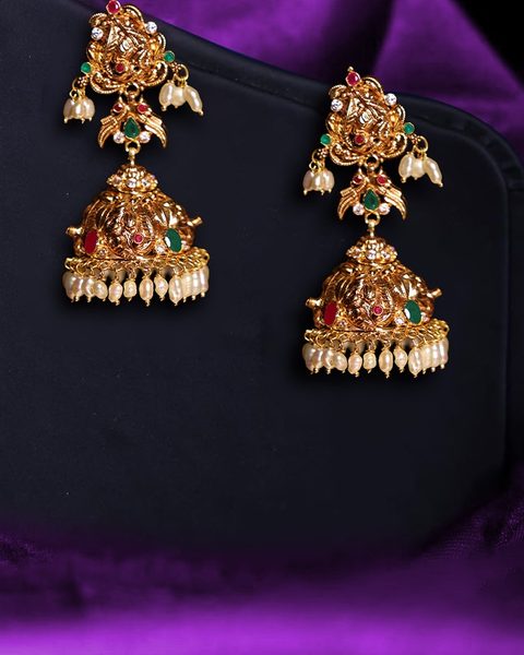 Antique gold jhumkas with floral top, red and green stones and pearl fringe. Photographed at the shop.