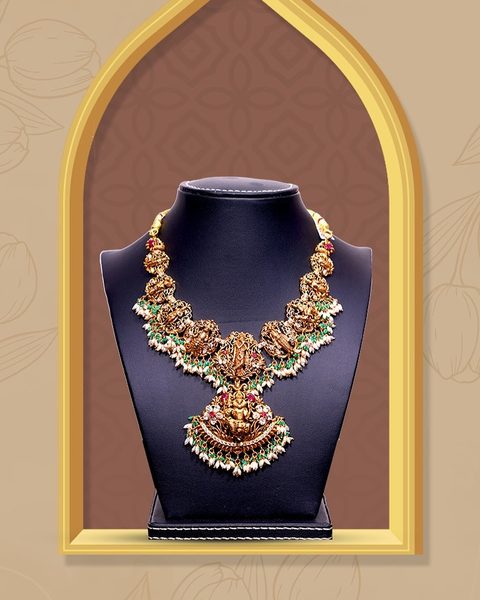 Nakshi necklace with lakshmi pendant, pearl fringe and green bead accents. Photographed at the shop.