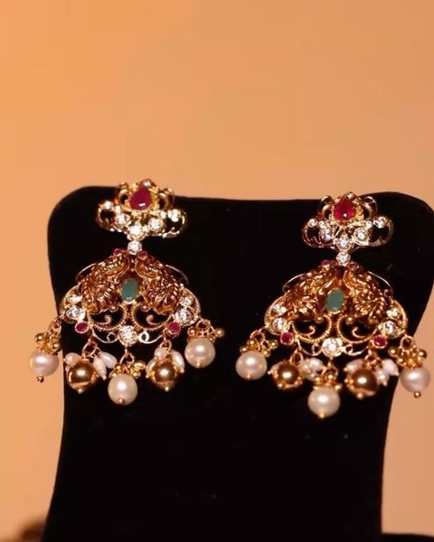 Cz chandbali earrings with ruby top, emerald centre and pearl drops. Photographed at the shop.