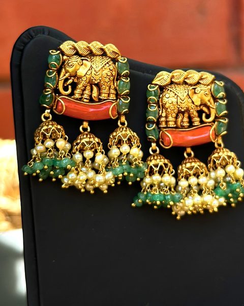 Elephant motif earrings with coral bar, emerald beads and pearl fringe jhumka clusters. Photographed at the shop.