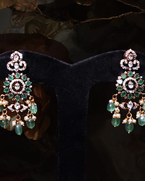 Pair of cz chandelier earrings with emerald stones, pearl and emerald bead drops. Photographed at the shop.