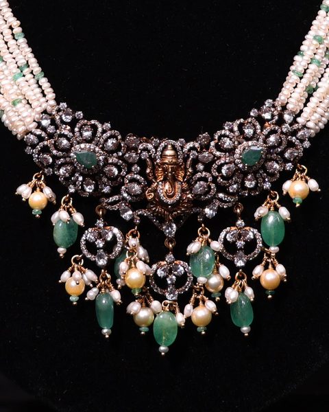 Victorian CZ necklace with gold Ganesha centre, pearl strands and emerald bead drops. Photographed at the shop.