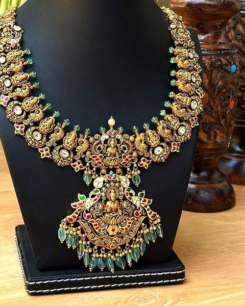 Nakshi necklace with lakshmi pendant, polki stones, kempu accents and emerald bead drops. Photographed at the shop.