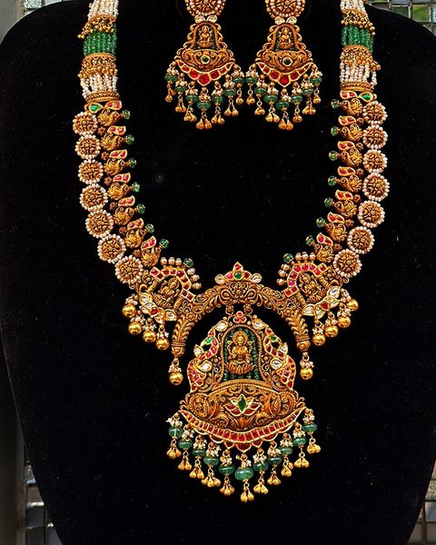Long nakshi haram with lakshmi pendant, pearl cluster links and matching jhumkas. Photographed at the shop.