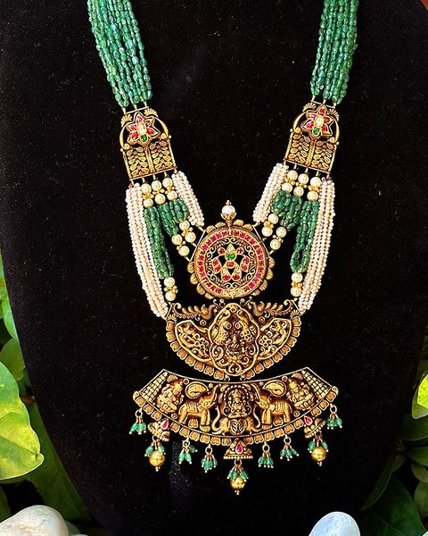 Multi strand emerald bead haram with kempu medallion and lakshmi elephant pendant. Photographed at the shop.