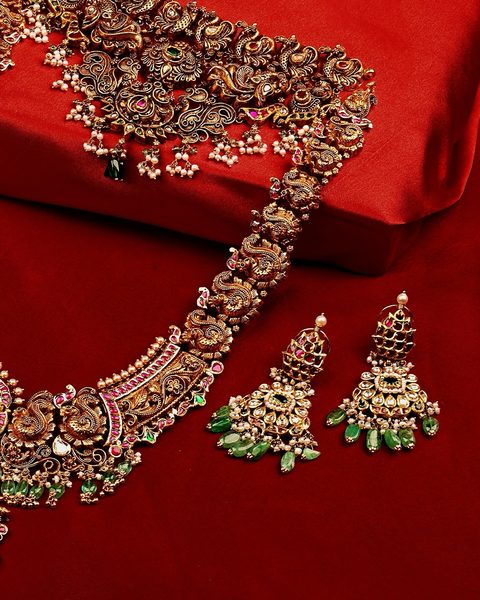 Antique nakshi choker and long haram with peacock motifs, emerald drops and jhumka earrings. Photographed at the shop.