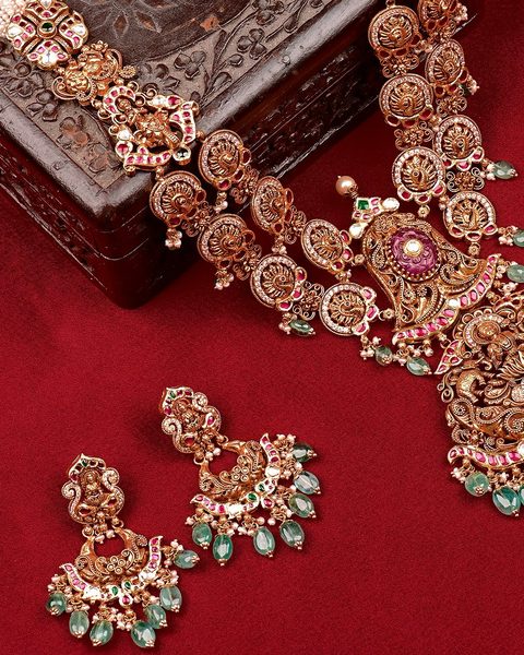 Antique nakshi haram with peacock discs, lakshmi pendant, carved ruby, emerald drops, chandbali earrings. Photographed at the shop.