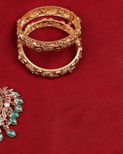 Pair of antique nakshi bangles, nakshi pendant with emerald drops cut off at left. Photographed at the shop.