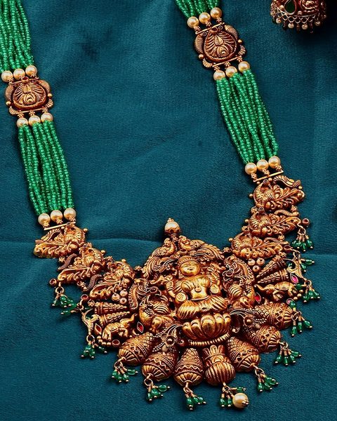 Multi strand emerald bead haram with nakshi lakshmi pendant and peacock spacers. Photographed at the shop.