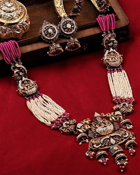 Victorian nakshi haram with lakshmi motifs, ruby and pearl strands, bangles and earrings. Photographed at the shop.