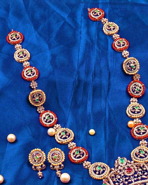 Long cz disc haram with coral and pearl rims, cz pendant and earrings. Photographed at the shop.
