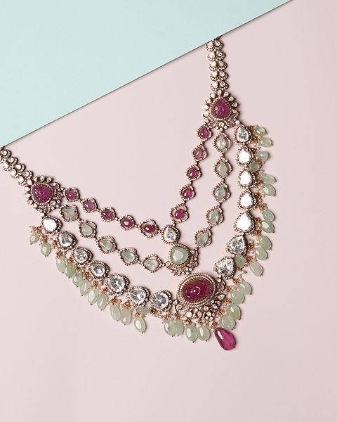 Three layer polki necklace with carved rubies and emerald bead drops. Photographed at the shop.