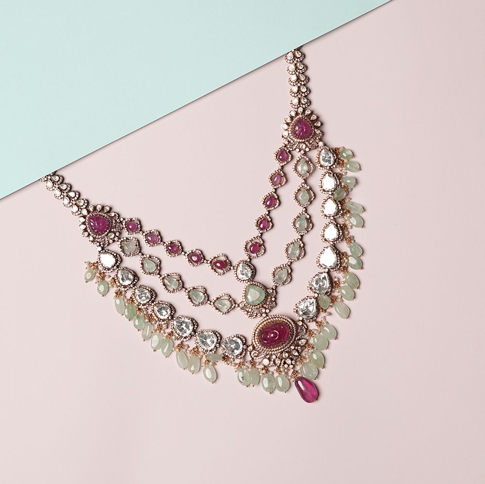 Three strand polki necklace with carved rubies and pale green drops.